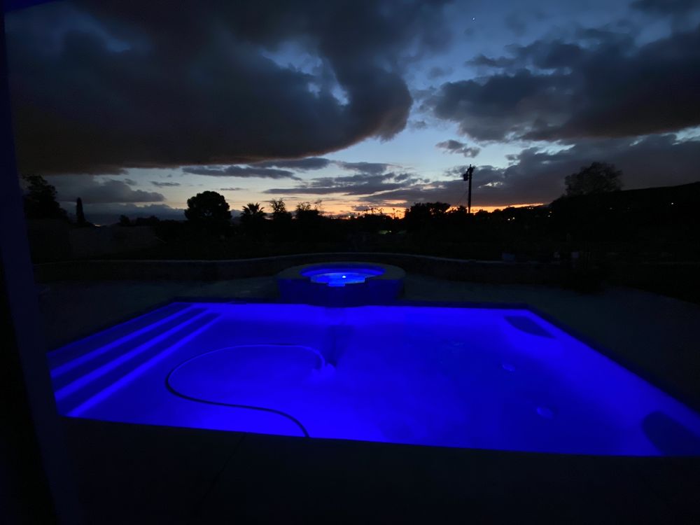 Southern California Backyard Pool lit with blue LED light | Anderson Pool and Spa